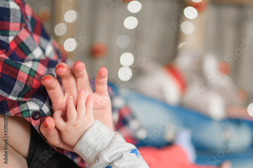 New Year's hands. baby and mom. mother's cares. christmas background