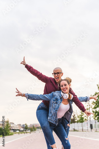 Hipster Woman Carrying Her Friend on her Back.
