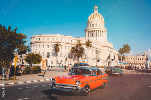 Vintage cars next to the iconic Capitol building in Havana © kmiragaya
