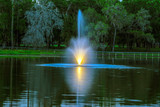 A fountain in at central Florida lake during the blue hour.