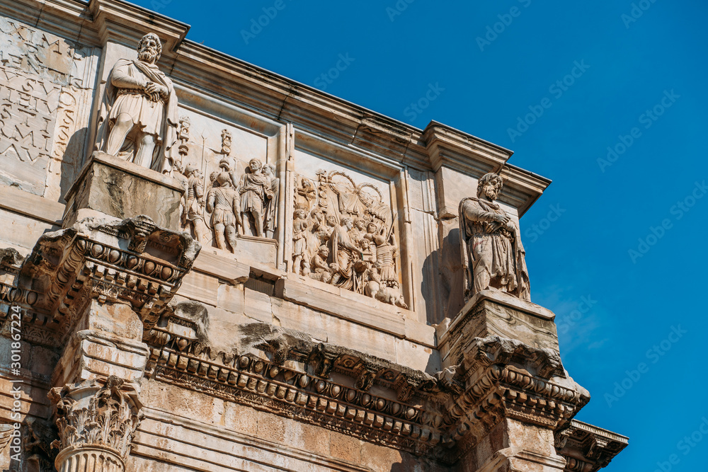 Arch of Constantine or Arco di Costantino or Triumphal arch in Rome, Italy near Coliseum, close up.