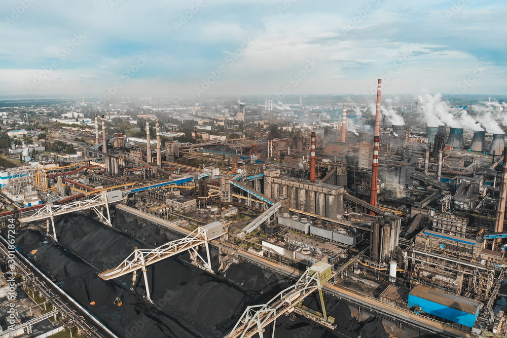 Aerial panoramic view of Factory or Plant Industrial Area with many pipes or chimneys with smoke, drone photo.