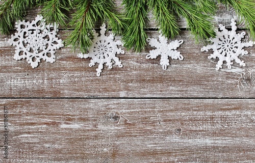 New Year and Christmas background. pine branches and lace knitted snowflakes against the background of old boards. snowflakes, lace, openwork knitting, handmade. copy space. place for text. Flatlay