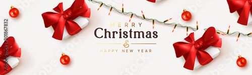 Christmas banner. Background Xmas design of sparkling lights garland, realistic gifts box, red ball. Holiday ornaments baubles, presents. Horizontal New Year poster, greeting card, headers for website