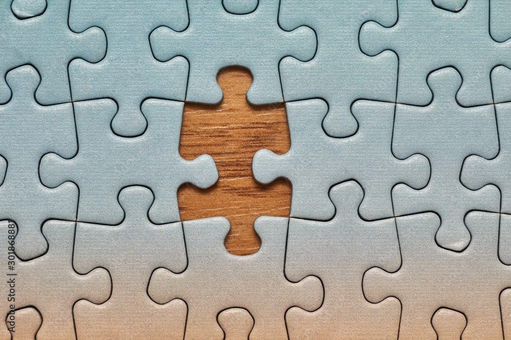 Jigsaw puzzle background, one last piece missing only, almost complete Jigsaw puzzle background, one last piece missing only, almost complete