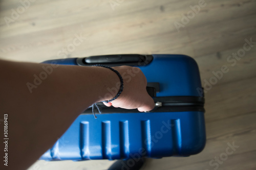 Man's hand carrying luggage photo