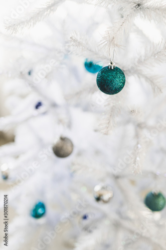 christmas tree with white frosted snow style and blue and silver toned baubles decoration photo