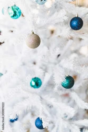 christmas tree with white frosted snow style and blue and silver toned baubles decoration photo