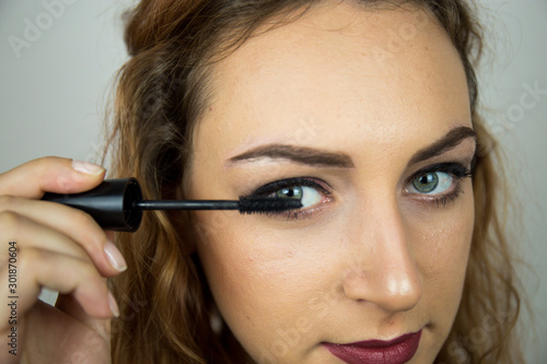 Portrait  beautiful girl  make-up  with smile posing on white background  makeup  powder  eye shadow  mascara  lipstick  eyeshadow