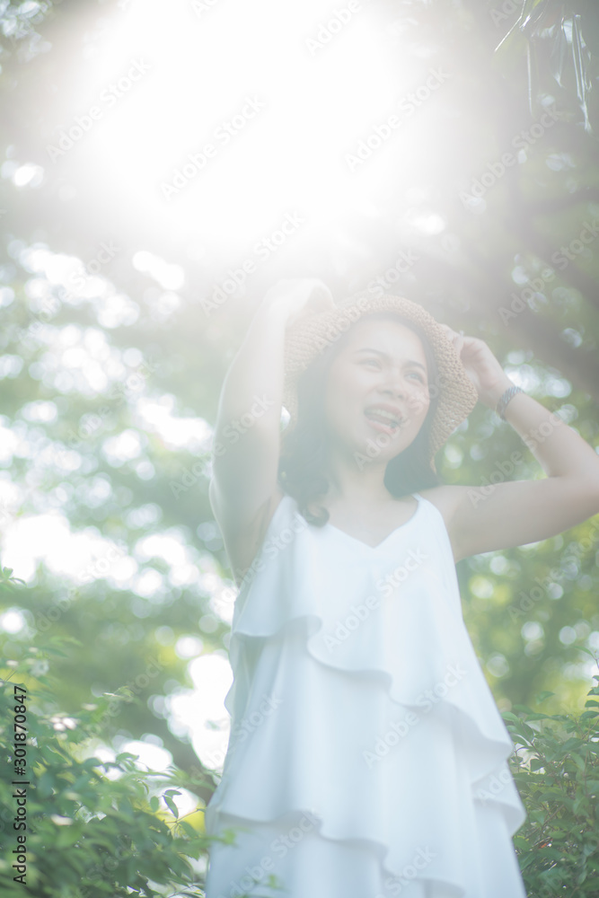 Naklejka premium Portrait of asian women enjoying freedom in city park morning sun light