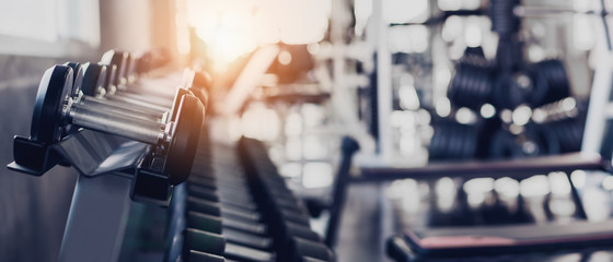 Fotobehang Fitness Dumbbells in rek bij fitnessruimte  © Mongkolchon
