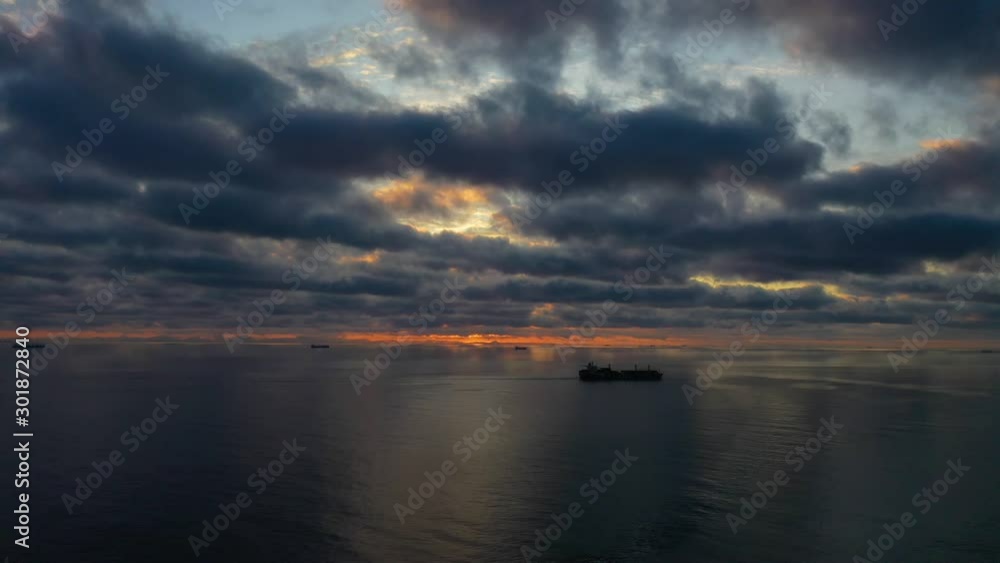 Beautiful sunset with clouds and ships aerial drone shot over the ocean in 4k Beautiful sunset with clouds and ships aerial drone shot over the ocean in 4k
