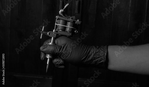 tattoo accessories and steel tubes in hand