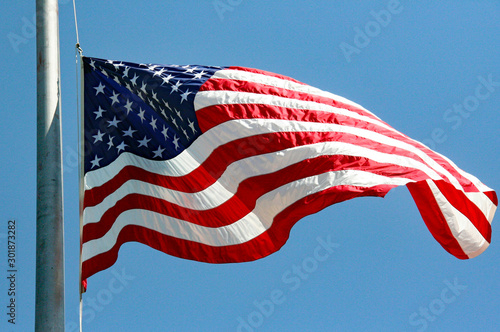 U.S. flag waves from flagpole photo