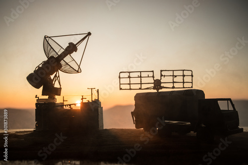 Satellite dishes or radio antennas against evening sky. Selective focus