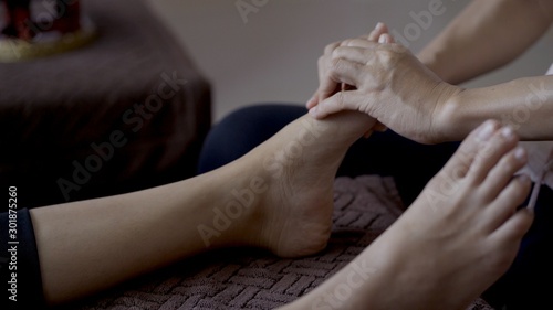 Woman very relaxing with foot massage procedure in spa salon during treatment © pixs4u