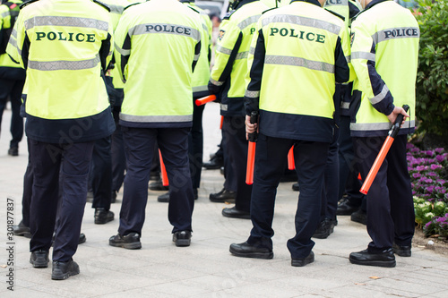 Seoul, South Korea - Nov 2, 2019: Korean policemen in bright vest uniform, controlling a demonstration on street