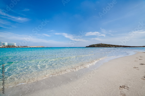 Famous Nissi beach, Ayia Napa. Famagusta District, Cyprus. Traces on sand and blue lagoon.
