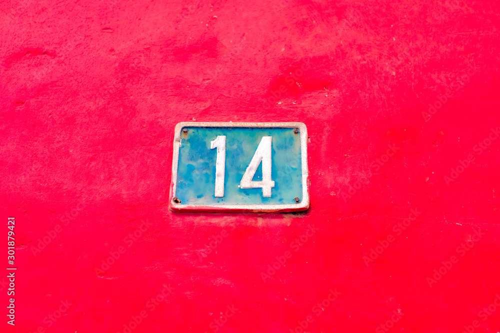 Number 14, fourteen, blue plate on bold red background. Number 14, fourteen, blue plate on bold red background.