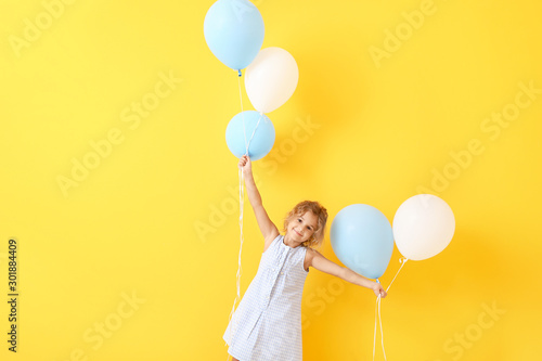 Little girl with balloons o...