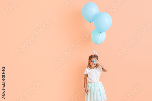 Little girl with balloons a...