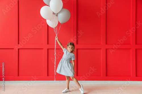 Little girl with balloons n...