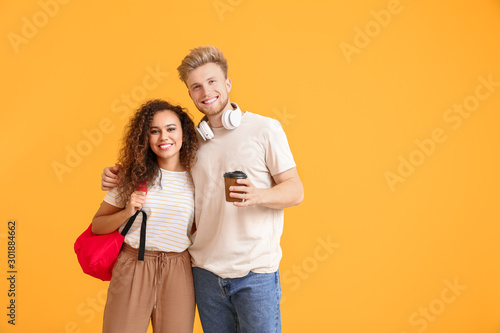 Portrait of female and male students on color background © Pixel-Shot