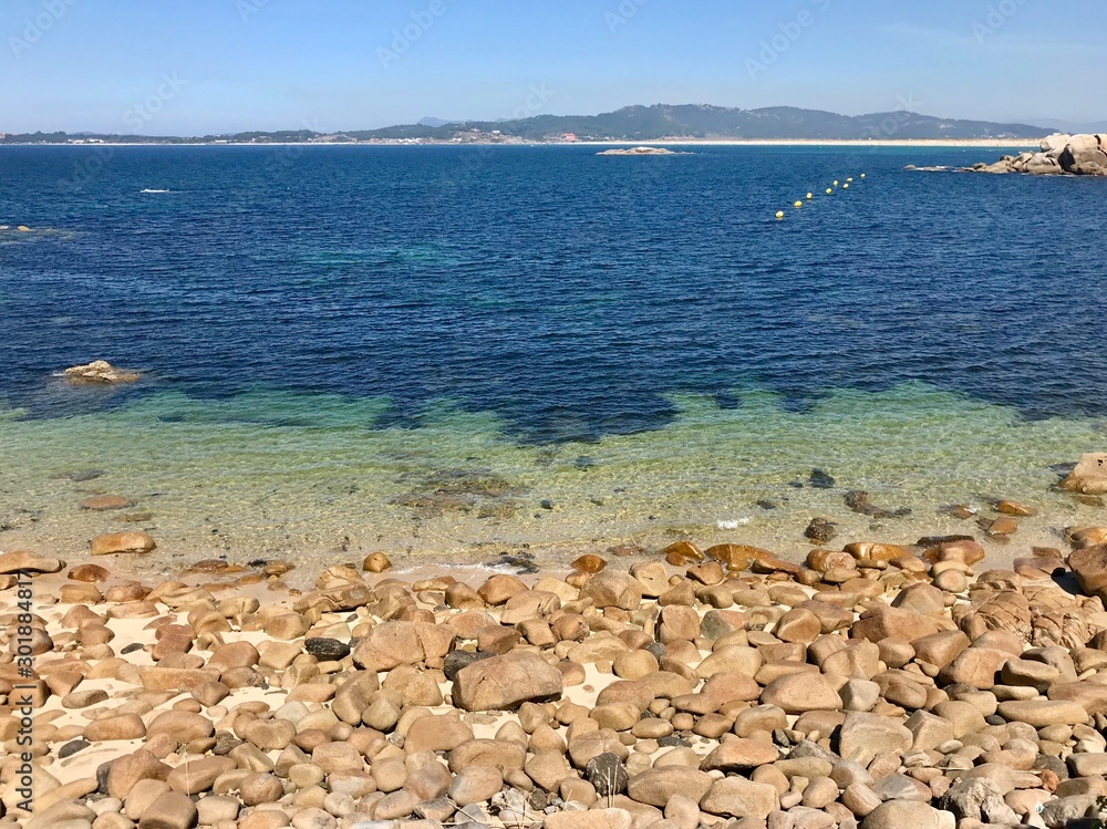 View of the ocean from above the rocks in Sanxenxo Galicia Spain during a summer day