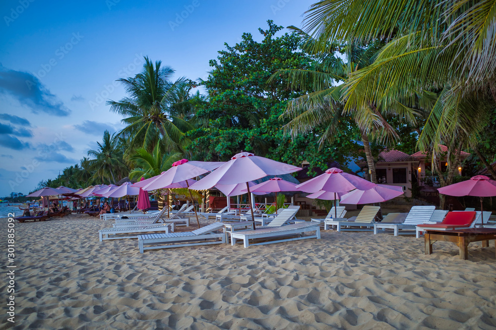 Phu Quoc island, Vietnam - March 30, 2019: Sandy beach with palm trees on the shore of the Gulf of Thailand, Indian Ocean.