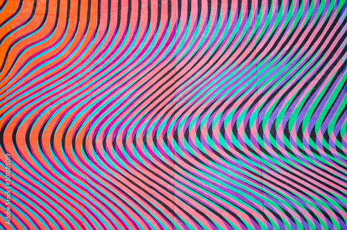 The wall in curved stripes of different colors.