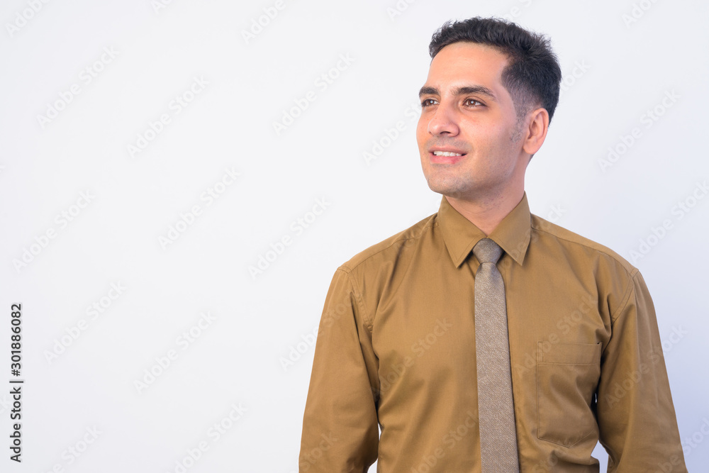Face of happy handsome Persian businessman thinking Face of happy handsome Persian businessman thinking