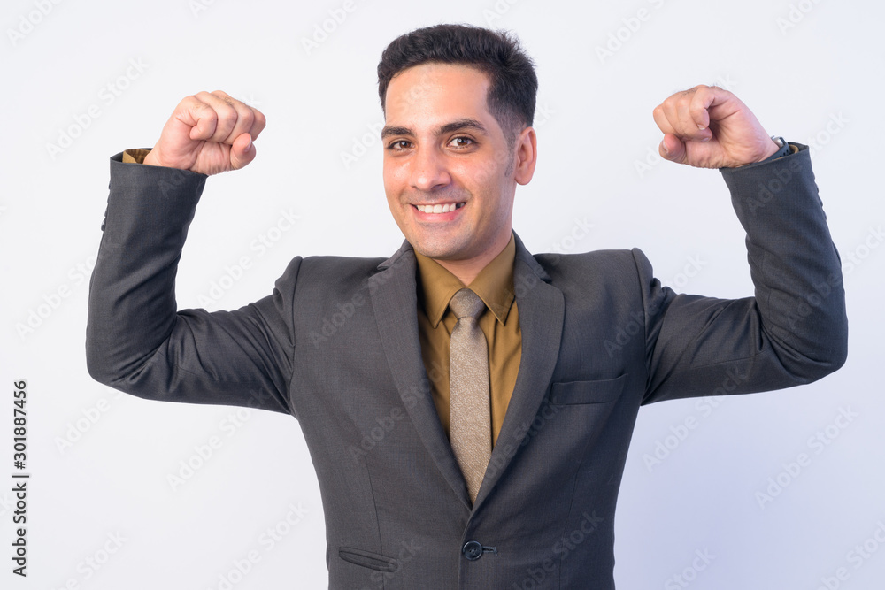 Portrait of happy Persian businessman in suit flexing both arms Portrait of happy Persian businessman in suit flexing both arms