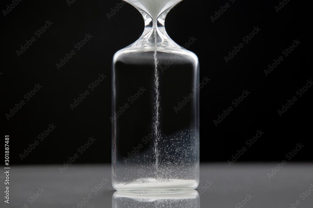 Hourglass on a dark background. Time is money. Business solutions in time. Hourglass on a dark background. Time is money. Business solutions in time.