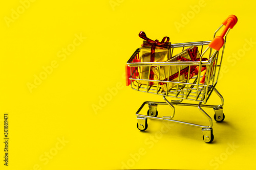 shopping cart toy with on yellow background.