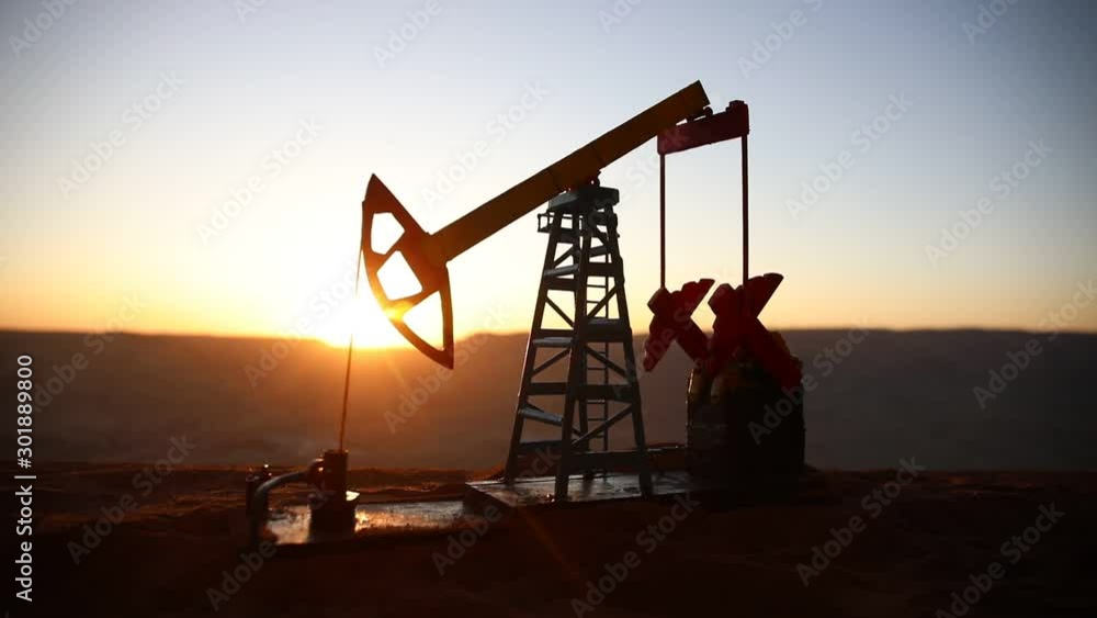 Oil pump and oil refining factory at sunset. Energy industrial concept. Selective focus. Creative artwork decoration. Oil pump and oil refining factory at sunset. Energy industrial concept. Selective focus. Creative artwork decoration.