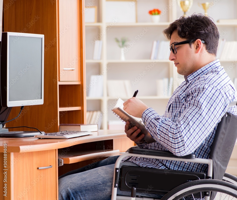 Obraz premium Disabled student studying at home on wheelchair
