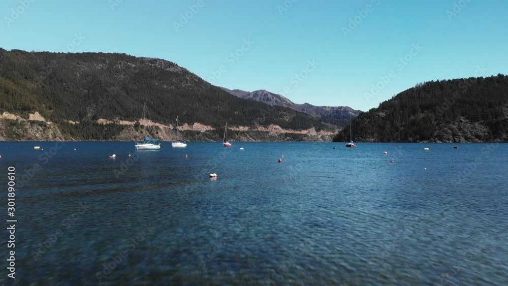 Amazing lake with boats surrounded of mountains Amazing lake with boats surrounded of mountains