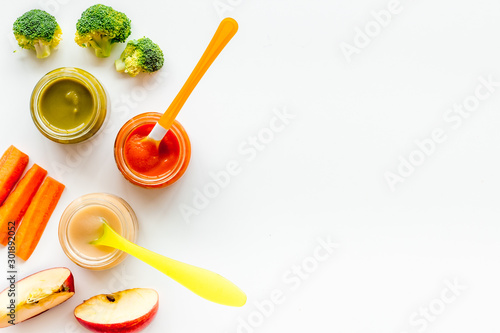 Mashed food for small babies. Colorful vegetable puree on white background top view copy space