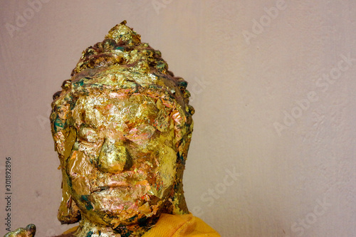 Thai ancient old golden Buddha face statue at the temple.