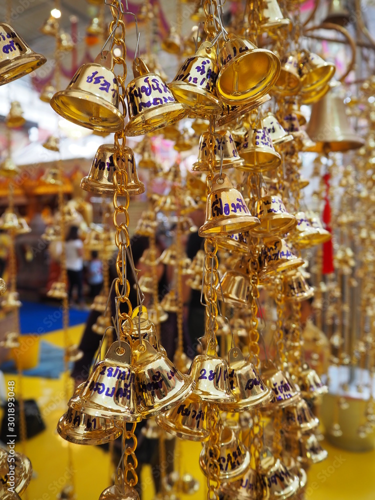 Close up of polished brass bells hanging bunch at thailand temple Close up of polished brass bells hanging bunch at thailand temple