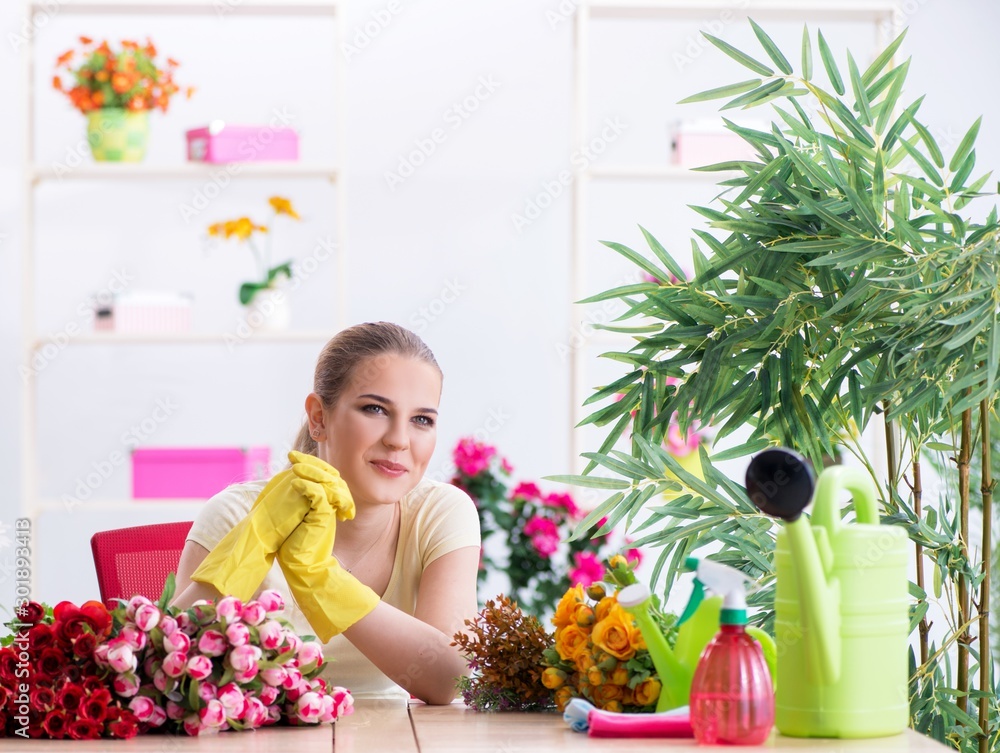 Young woman watering plants in her garden