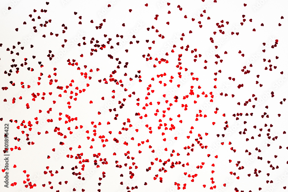 Valentine's Day background - scattered heart shaped confetti over white background. Valentine's Day background - scattered heart shaped confetti over white background.