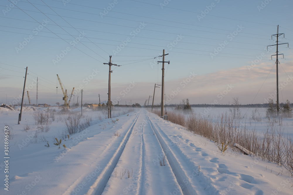 Railway tracks in winter near the industrial zone