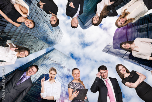 Collage of business people over cityscape background. photo