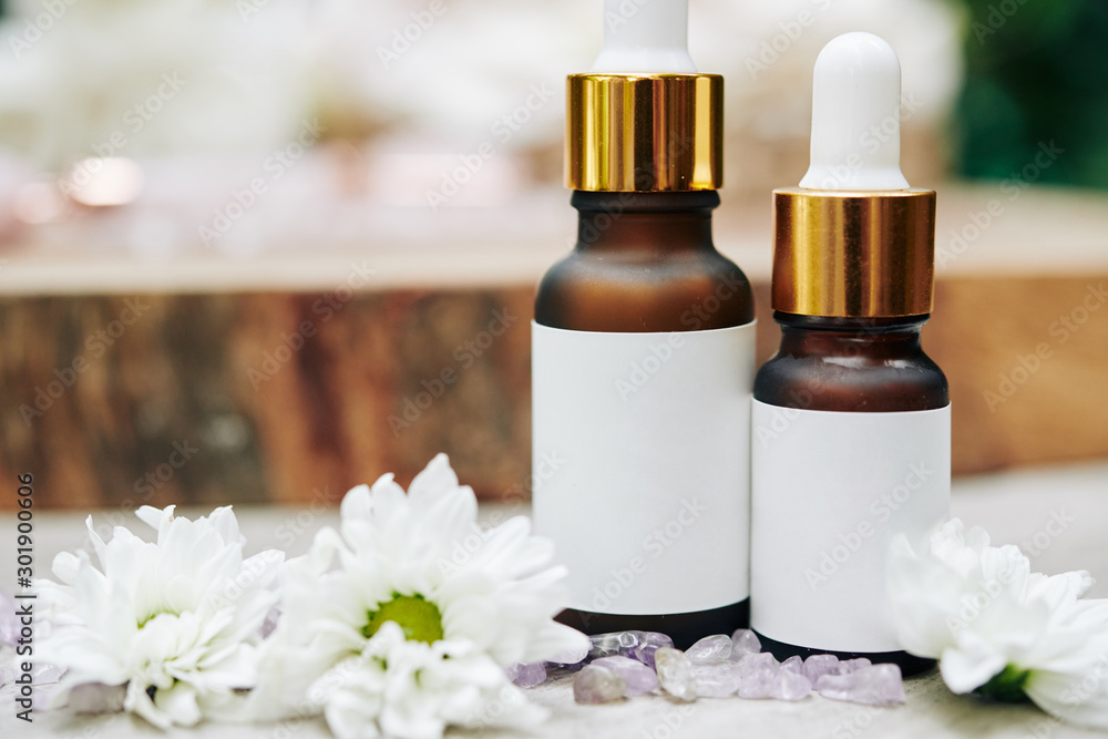 Close-up image of serums with organic ingredients with white black stickers Close-up image of serums with organic ingredients with white black stickers