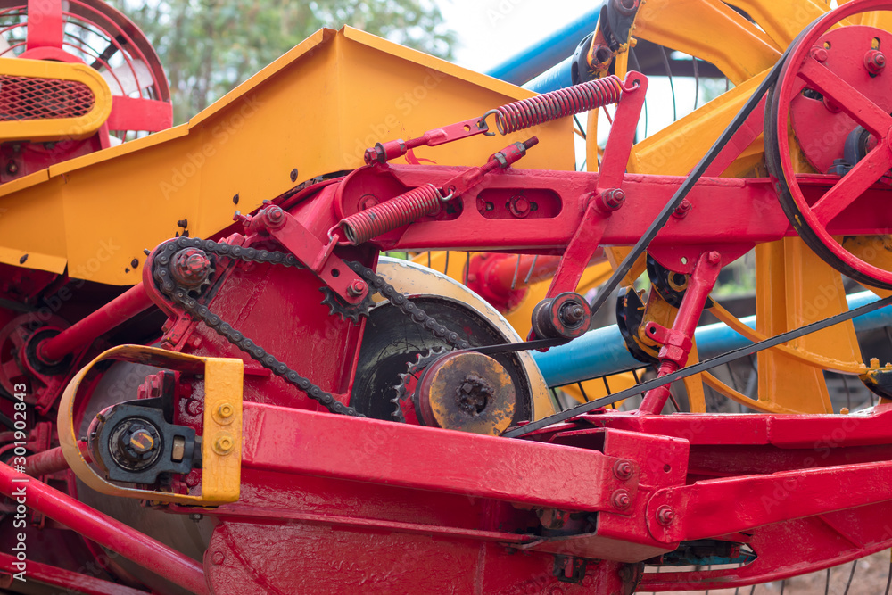 Close-up of the yellow and red combine harvesters. Close-up of the yellow and red combine harvesters.