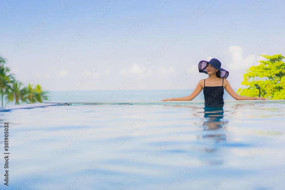 Obraz premium Portrait beautiful young asian women happy smile relax outdoor swimming pool in hotel