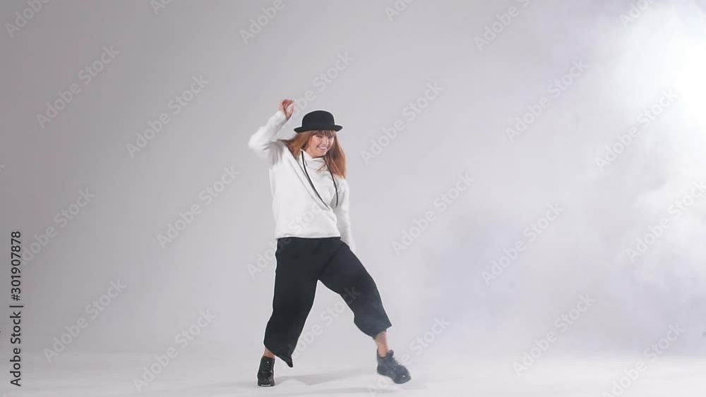 Flexible professional female dancer demonstrating dancing skill, hip hop dancer performing on stage Flexible professional female dancer demonstrating dancing skill, hip hop dancer performing on stage
