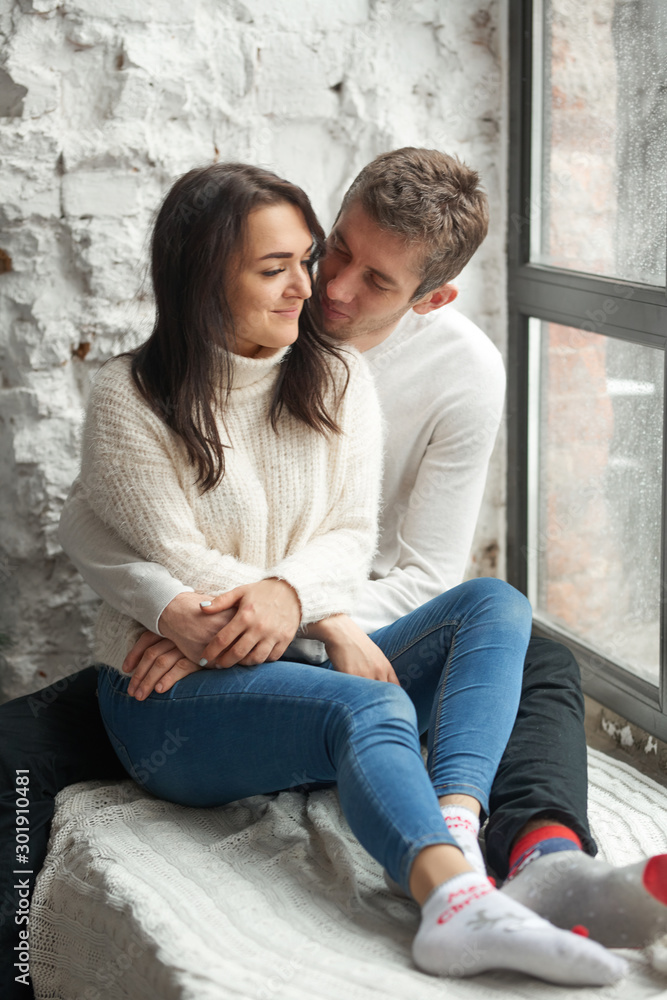 Loving couple on a light background on the windowsill. Love, cares, warmth. Loving couple on a light background on the windowsill. Love, cares, warmth.