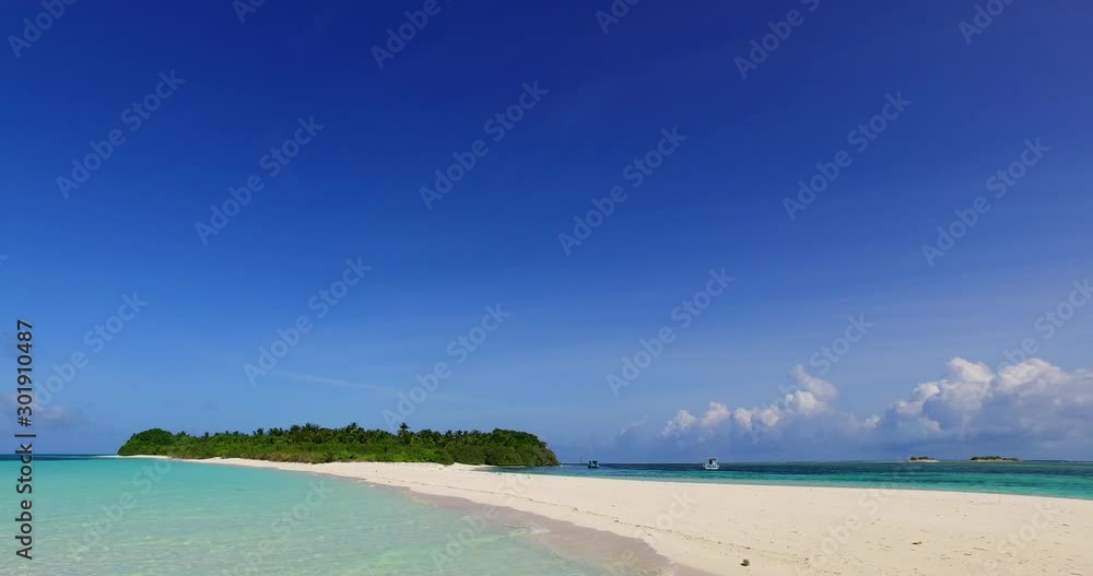 Low angle shot of an exotic island with a long sandbar in the Maldives Low angle shot of an exotic island with a long sandbar in the Maldives